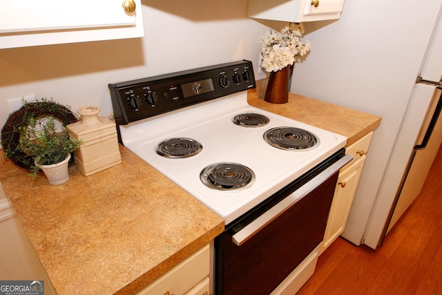 555 Flintlock Dr, Dacula, GA 30019 - kitchen featuring white electric range, light countertops, and wood finished floors