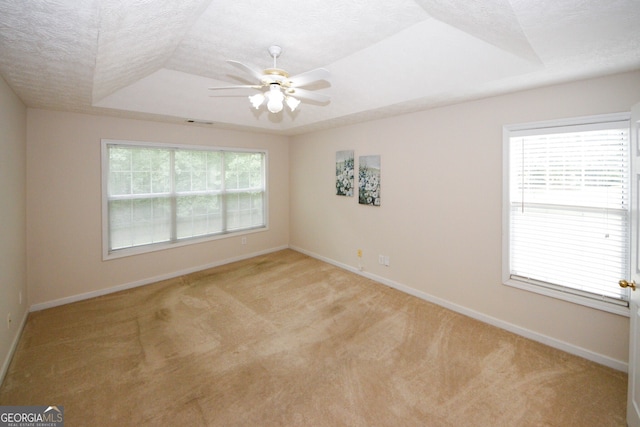 555 Flintlock Dr, Dacula, GA 30019 - spare room with a tray ceiling, carpet floors, a ceiling fan, and a textured ceiling