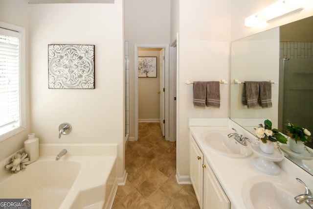 555 Flintlock Dr, Dacula, GA 30019 - full bath featuring plenty of natural light, double vanity, and a garden tub