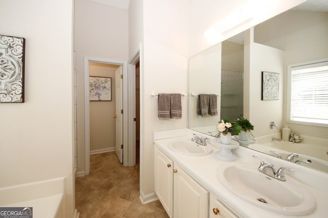 555 Flintlock Dr, Dacula, GA 30019 - bathroom with double vanity and a tub to relax in