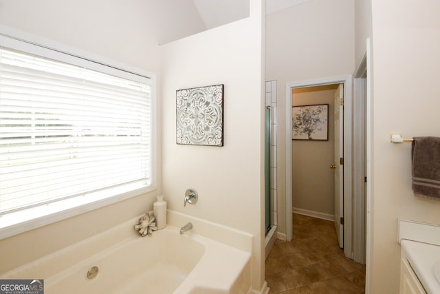 555 Flintlock Dr, Dacula, GA 30019 - bathroom featuring a bath, a shower with door, and tile patterned flooring