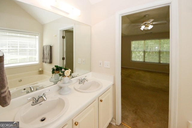 555 Flintlock Dr, Dacula, GA 30019 - bathroom with plenty of natural light, double vanity, a bathtub, vaulted ceiling, and ceiling fan