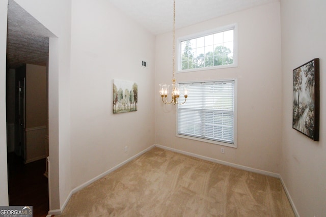 555 Flintlock Dr, Dacula, GA 30019 - unfurnished dining area with a chandelier and carpet flooring