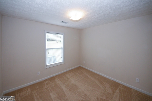555 Flintlock Dr, Dacula, GA 30019 - unfurnished room with light carpet and a textured ceiling