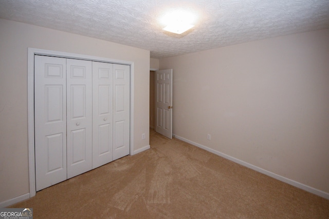 555 Flintlock Dr, Dacula, GA 30019 - unfurnished bedroom featuring carpet floors, a closet, and a textured ceiling