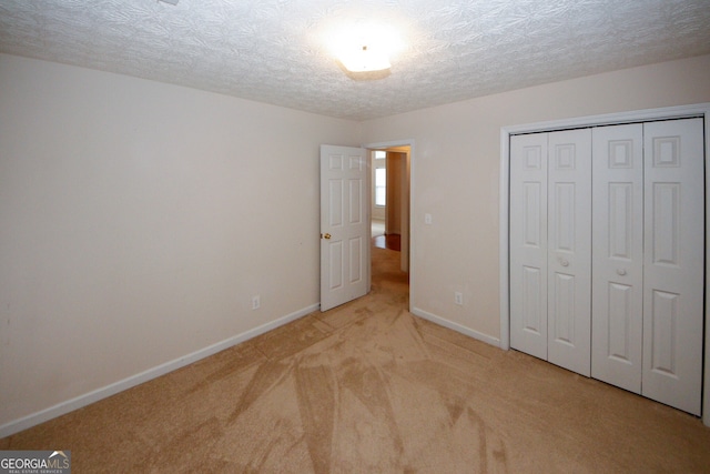 555 Flintlock Dr, Dacula, GA 30019 - unfurnished bedroom featuring carpet flooring, a closet, and a textured ceiling
