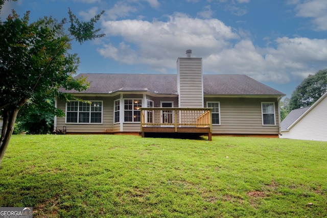 555 Flintlock Dr, Dacula, GA 30019 - rear view of house with a wooden deck, a lawn, a chimney, and a shingled roof