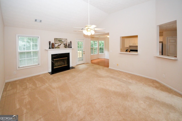 555 Flintlock Dr, Dacula, GA 30019 - unfurnished living room featuring light carpet, a fireplace, a ceiling fan, and lofted ceiling
