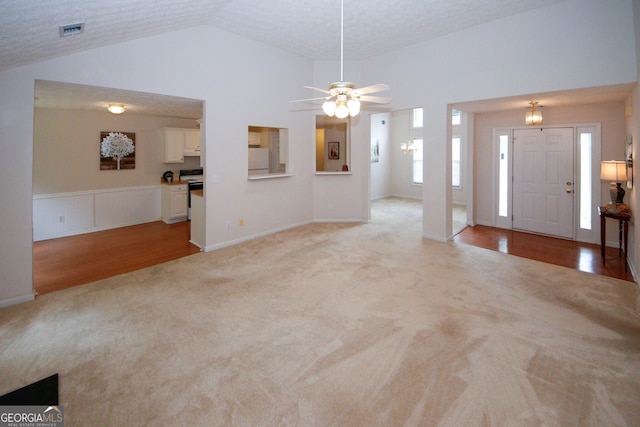555 Flintlock Dr, Dacula, GA 30019 - entryway with light carpet, vaulted ceiling, ceiling fan, and wainscoting