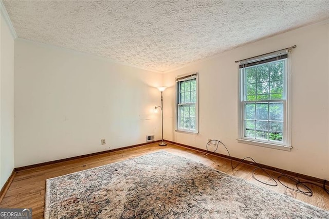 2867 Holly Oaks Dr, Marietta, GA 30062 - spare room featuring wood finished floors, a textured ceiling, and crown molding