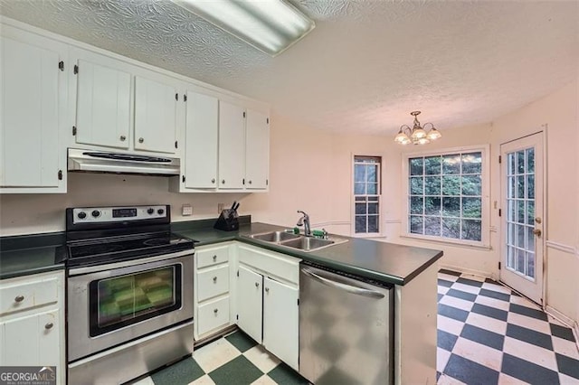 2867 Holly Oaks Dr, Marietta, GA 30062 - kitchen with stainless steel appliances, light flooring, dark countertops, under cabinet range hood, and a textured ceiling