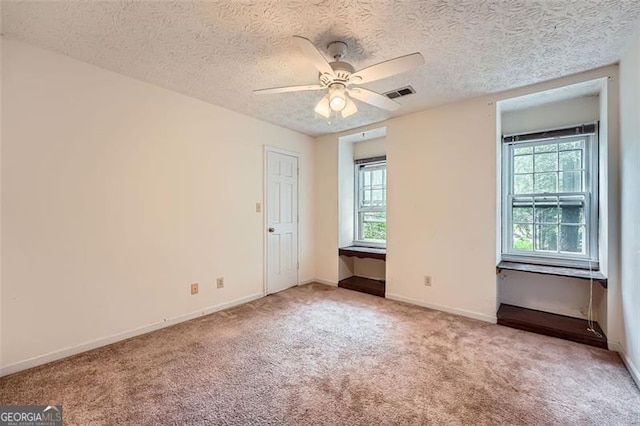 2867 Holly Oaks Dr, Marietta, GA 30062 - unfurnished room with plenty of natural light, carpet flooring, a ceiling fan, and a textured ceiling