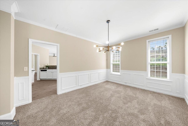 3559 Reservoir Pass, Acworth, GA 30101 - unfurnished room featuring light carpet, a chandelier, ornamental molding, and a wainscoted wall