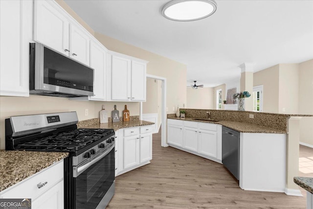 3559 Reservoir Pass, Acworth, GA 30101 - kitchen with stainless steel appliances, light wood-style floors, a ceiling fan, and white cabinets
