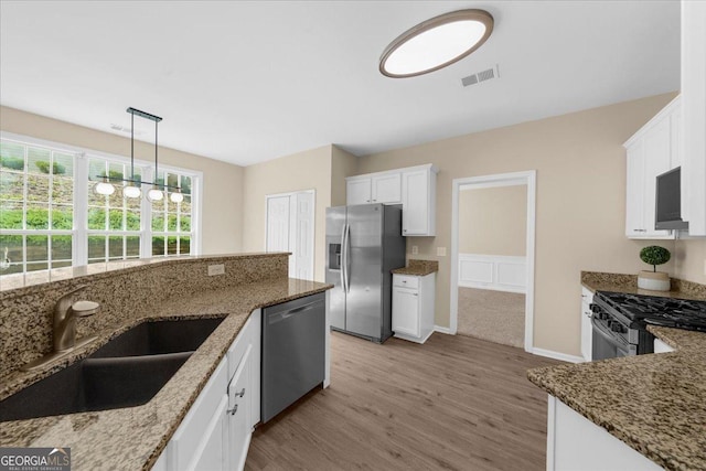 3559 Reservoir Pass, Acworth, GA 30101 - kitchen with stainless steel appliances, light wood-type flooring, stone countertops, and white cabinets