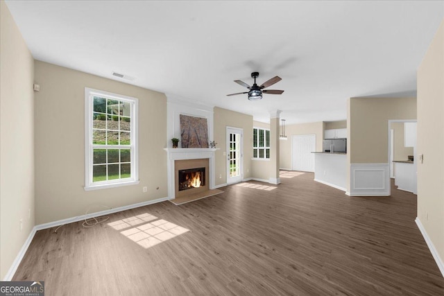 3559 Reservoir Pass, Acworth, GA 30101 - unfurnished living room featuring dark wood finished floors, a warm lit fireplace, and ceiling fan