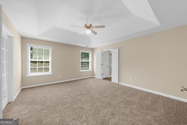 3559 Reservoir Pass, Acworth, GA 30101 - unfurnished bedroom with a raised ceiling, carpet, multiple windows, and ceiling fan