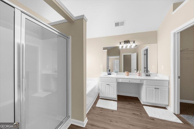 3559 Reservoir Pass, Acworth, GA 30101 - bathroom featuring a stall shower, double vanity, a bath, wood finished floors, and a walk in closet