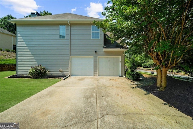 3559 Reservoir Pass, Acworth, GA 30101 - view of home's exterior featuring an attached garage, concrete driveway, roof with shingles, a lawn, and a chimney