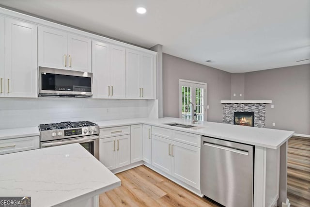 950 Mill Creek Ave, Canton, GA 30115 - kitchen with stainless steel appliances, light wood-style floors, a peninsula, open floor plan, and recessed lighting