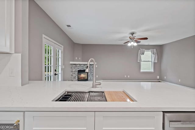 950 Mill Creek Ave, Canton, GA 30115 - kitchen with open floor plan, white cabinetry, a fireplace, and plenty of natural light