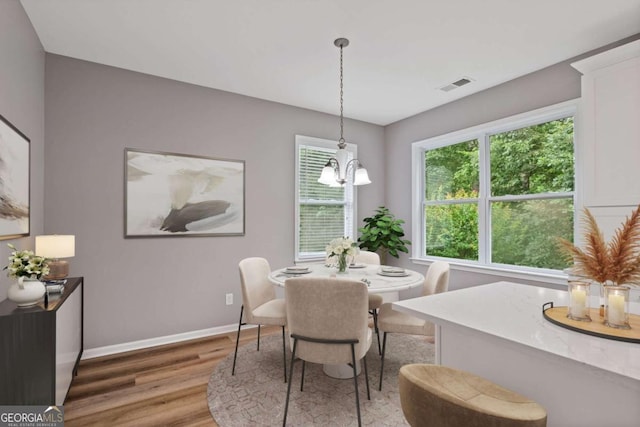 950 Mill Creek Ave, Canton, GA 30115 - dining room with light wood-type flooring and a chandelier