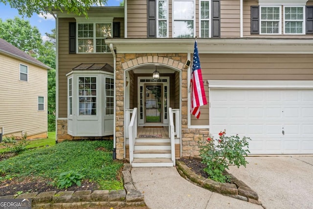 950 Mill Creek Ave, Canton, GA 30115 - doorway to property featuring stone siding, an attached garage, and concrete driveway