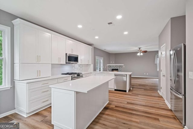 950 Mill Creek Ave, Canton, GA 30115 - kitchen featuring appliances with stainless steel finishes, a peninsula, healthy amount of natural light, light countertops, and recessed lighting