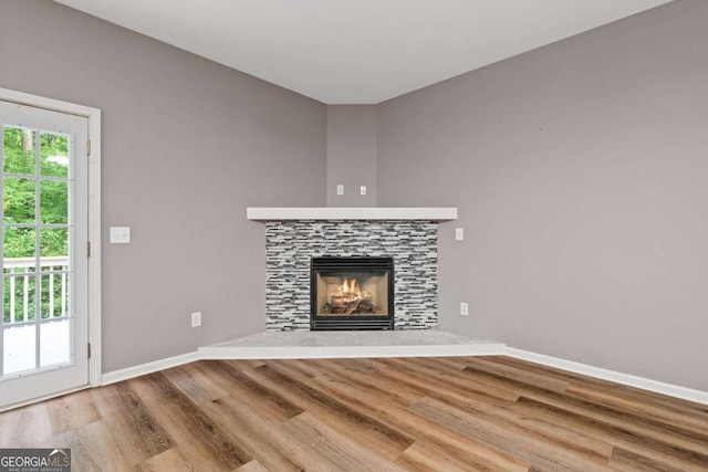 950 Mill Creek Ave, Canton, GA 30115 - unfurnished living room featuring wood finished floors and a fireplace