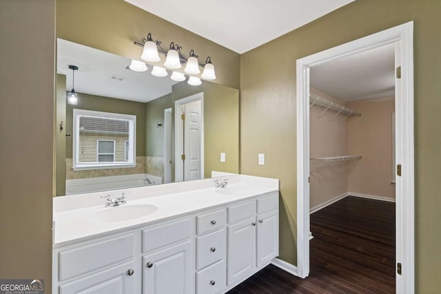 950 Mill Creek Ave, Canton, GA 30115 - full bath with double vanity, wood finished floors, a bath, and a spacious closet