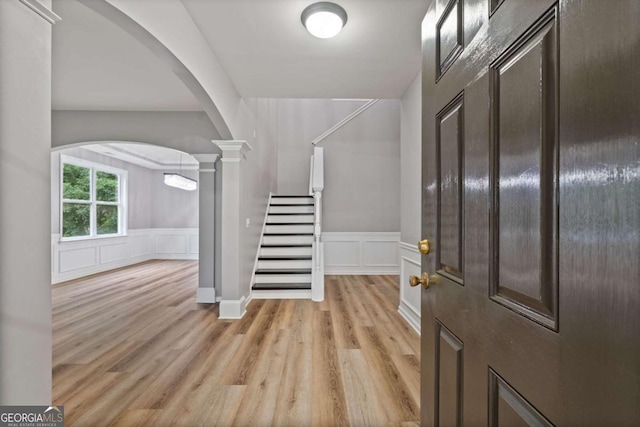 950 Mill Creek Ave, Canton, GA 30115 - entrance foyer with arched walkways, stairs, light wood-type flooring, wainscoting, and decorative columns