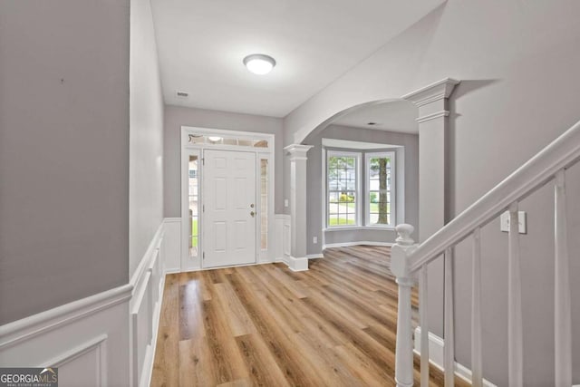 950 Mill Creek Ave, Canton, GA 30115 - entryway with decorative columns, arched walkways, light wood-type flooring, and stairway