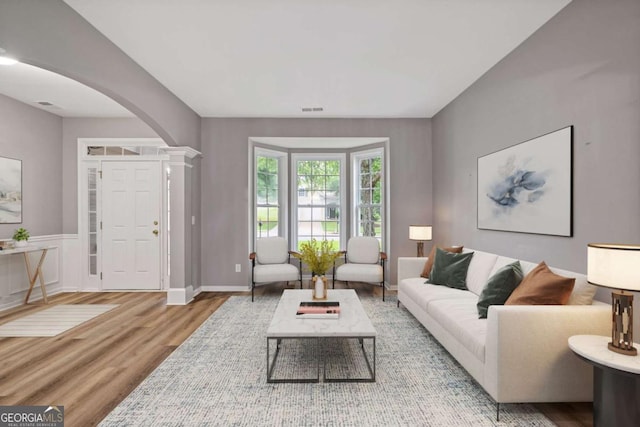 950 Mill Creek Ave, Canton, GA 30115 - living room featuring arched walkways, wood finished floors, and decorative columns