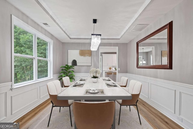 950 Mill Creek Ave, Canton, GA 30115 - dining area with wood finished floors, a decorative wall, a chandelier, a wainscoted wall, and a tray ceiling