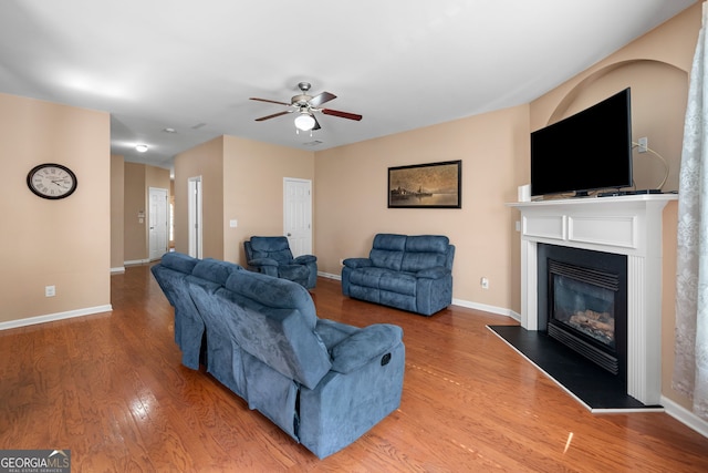 305 Hidden Creek Ln, Canton, GA 30114 - living room with wood finished floors, a ceiling fan, and a glass covered fireplace