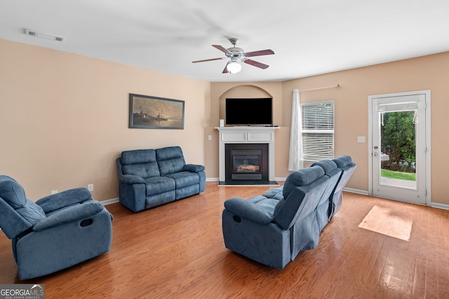 305 Hidden Creek Ln, Canton, GA 30114 - living area featuring a glass covered fireplace, wood finished floors, and ceiling fan