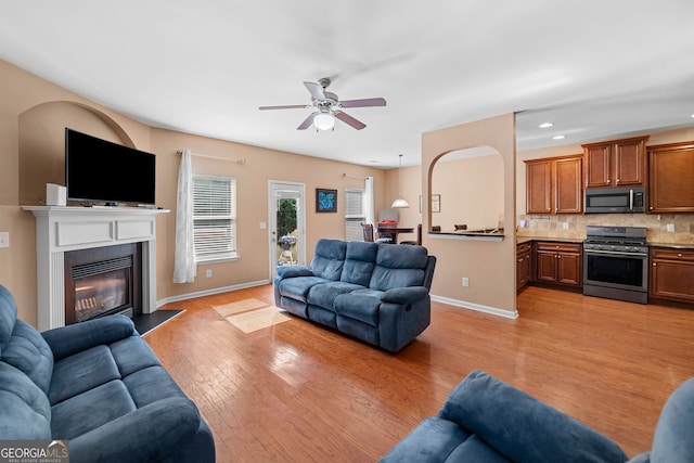 305 Hidden Creek Ln, Canton, GA 30114 - living area featuring a ceiling fan, light wood-style flooring, a glass covered fireplace, and recessed lighting