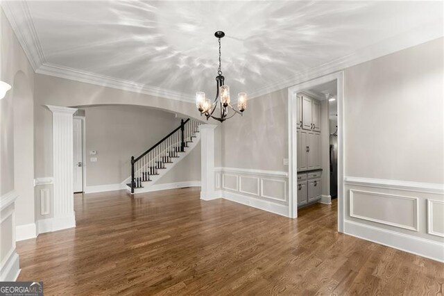 3311 Marina View Way, Gainesville, GA 30506 - unfurnished dining area featuring a decorative wall, arched walkways, stairs, a chandelier, and wood finished floors