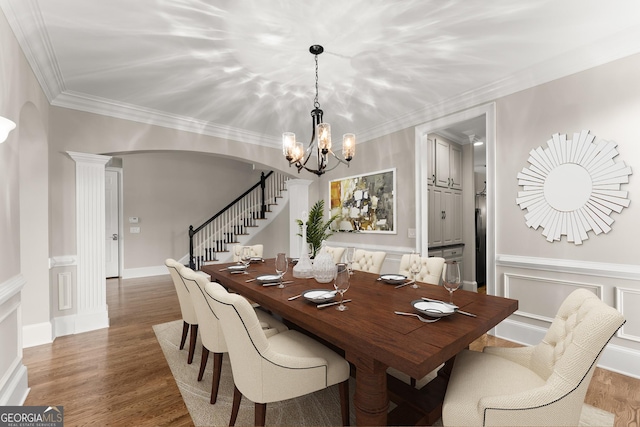 3311 Marina View Way, Gainesville, GA 30506 - dining space with a chandelier, stairs, arched walkways, wood finished floors, and ornate columns
