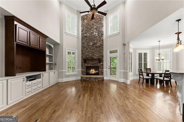 3311 Marina View Way, Gainesville, GA 30506 - living area with wood finished floors, a high ceiling, ceiling fan, a fireplace, and crown molding