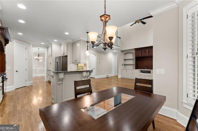 3311 Marina View Way, Gainesville, GA 30506 - dining room featuring a chandelier, ornamental molding, light wood finished floors, and recessed lighting