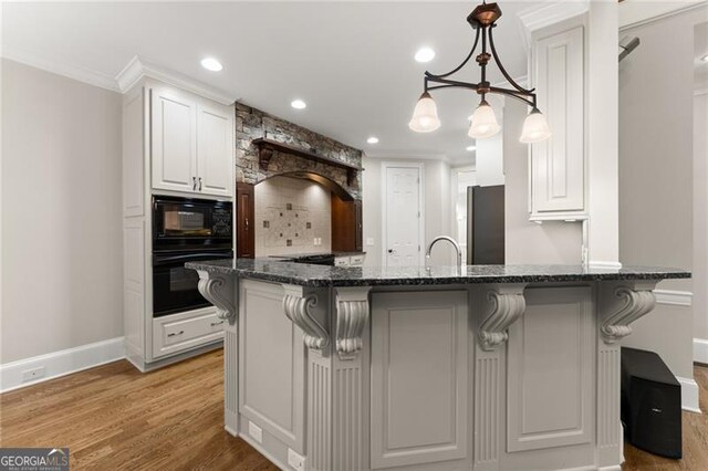 3311 Marina View Way, Gainesville, GA 30506 - kitchen featuring black appliances, white cabinets, light wood-style floors, a breakfast bar, and ornamental molding