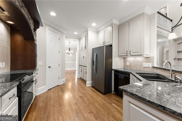 3311 Marina View Way, Gainesville, GA 30506 - kitchen with black appliances, decorative backsplash, a chandelier, dark stone countertops, and light wood-style flooring