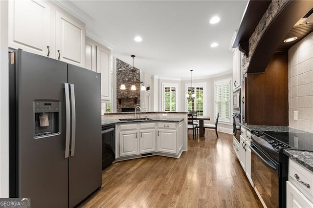 3311 Marina View Way, Gainesville, GA 30506 - kitchen featuring black appliances, a peninsula, white cabinets, tasteful backsplash, and wood finished floors