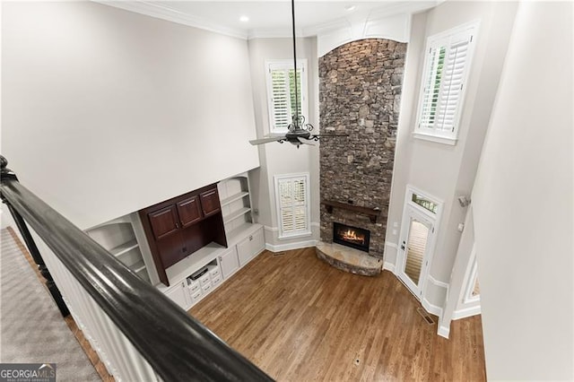 3311 Marina View Way, Gainesville, GA 30506 - unfurnished living room featuring a stone fireplace, wood finished floors, ornamental molding, and recessed lighting