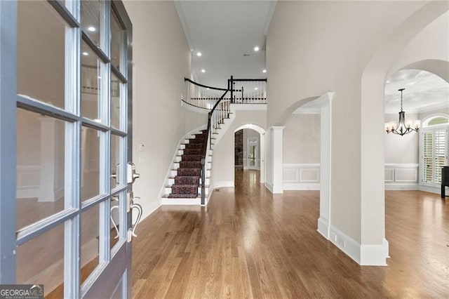 3311 Marina View Way, Gainesville, GA 30506 - foyer entrance with arched walkways, stairway, a chandelier, crown molding, and a high ceiling