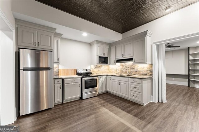 3311 Marina View Way, Gainesville, GA 30506 - kitchen with stainless steel appliances, an ornate ceiling, dark wood-type flooring, backsplash, and a ceiling fan