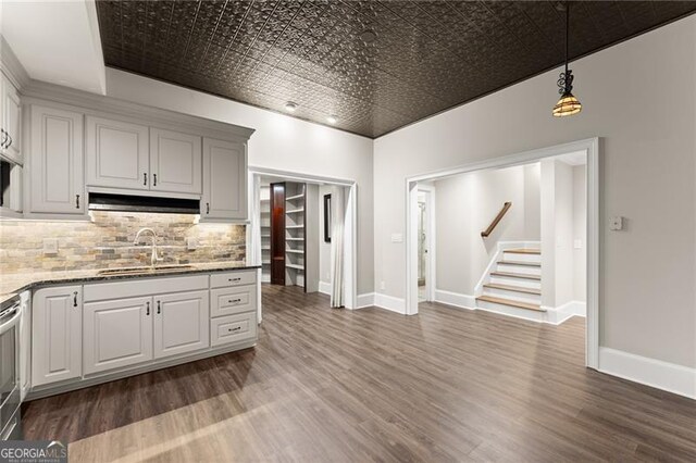 3311 Marina View Way, Gainesville, GA 30506 - kitchen featuring wood finished floors, an ornate ceiling, backsplash, decorative light fixtures, and light stone countertops