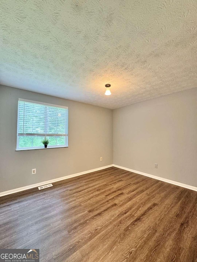 3544 Citrus Dr, Duluth, GA 30096 - empty room featuring dark wood-style floors and a textured ceiling