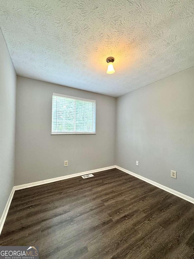3544 Citrus Dr, Duluth, GA 30096 - spare room featuring dark wood-style flooring and a textured ceiling